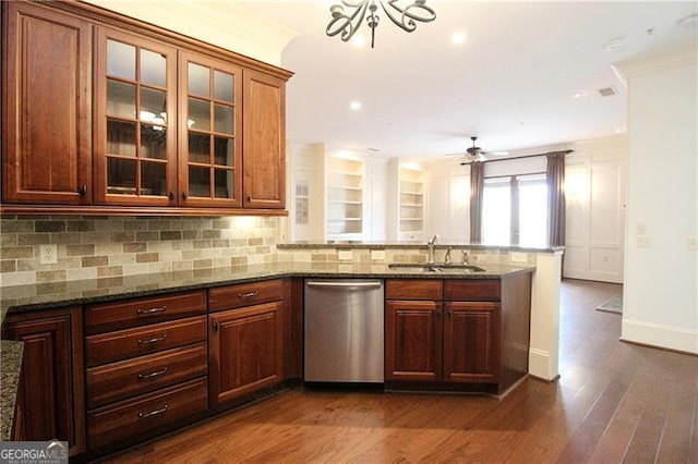 kitchen with stainless steel dishwasher, a sink, a peninsula, dark wood-style floors, and backsplash