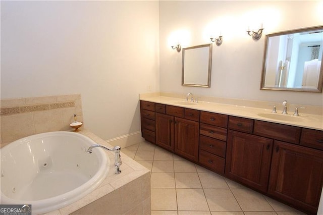 full bath with double vanity, a tub with jets, and tile patterned flooring