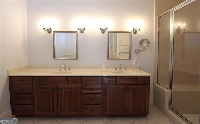 bathroom featuring a stall shower, double vanity, and tile patterned flooring