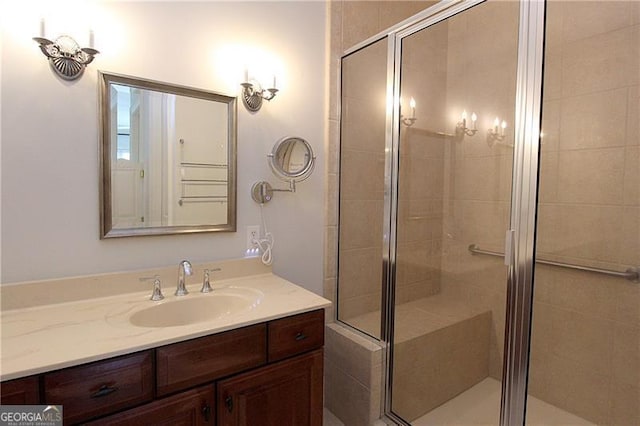 full bath with a shower stall and vanity