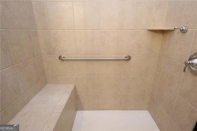 bathroom with tiled shower
