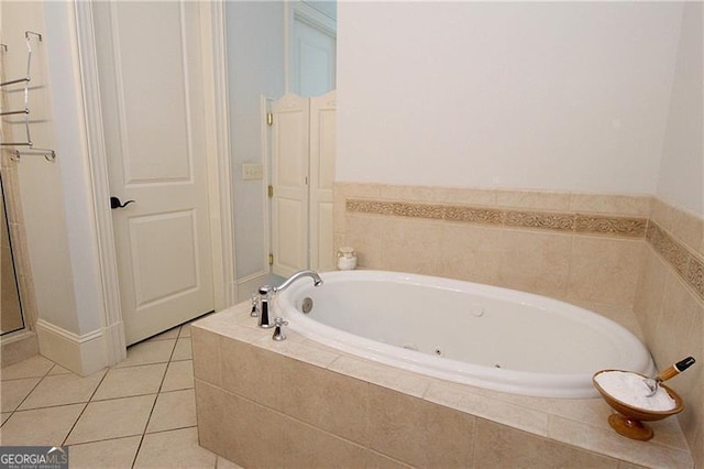 bathroom with a bath, tile patterned flooring, and a shower stall