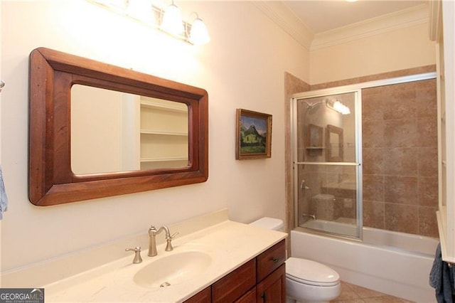 full bathroom featuring crown molding, toilet, vanity, and combined bath / shower with glass door