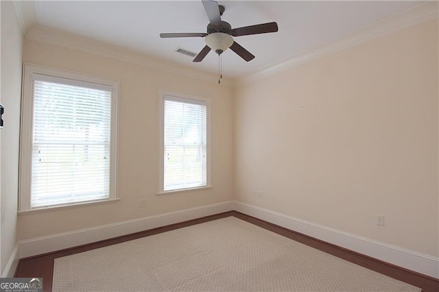 unfurnished room featuring crown molding, baseboards, and ceiling fan