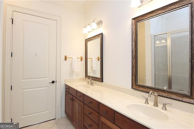 bathroom featuring ornamental molding, double vanity, tile patterned floors, and a shower with door