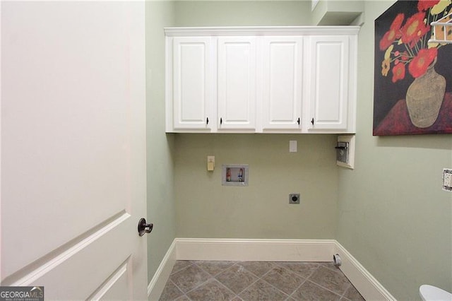 washroom featuring hookup for a washing machine, electric dryer hookup, baseboards, gas dryer hookup, and cabinet space