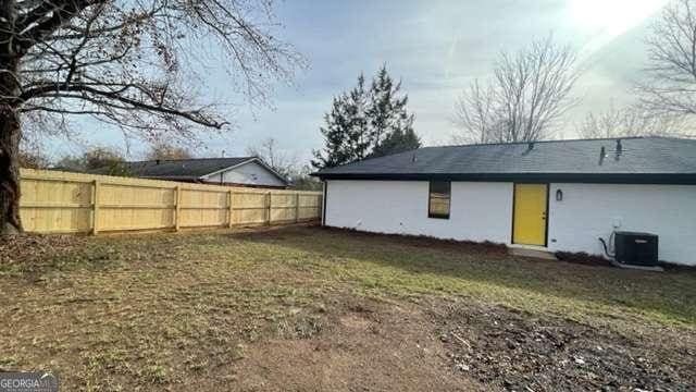 rear view of property featuring cooling unit