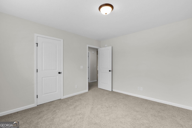 unfurnished bedroom featuring light colored carpet