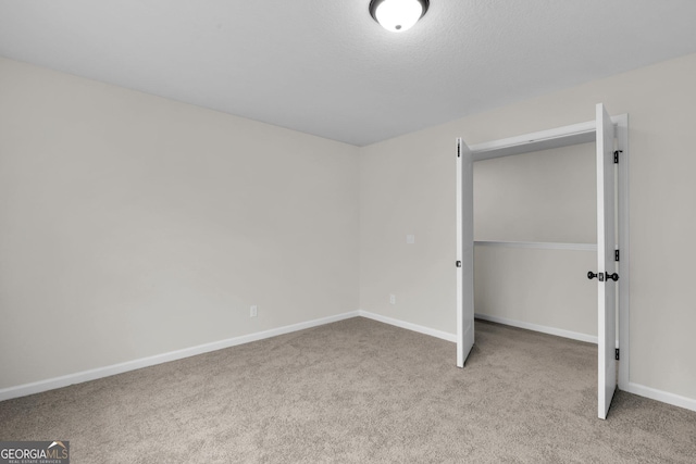 unfurnished bedroom with light carpet