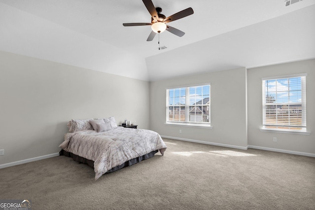 carpeted bedroom featuring multiple windows, ceiling fan, and lofted ceiling