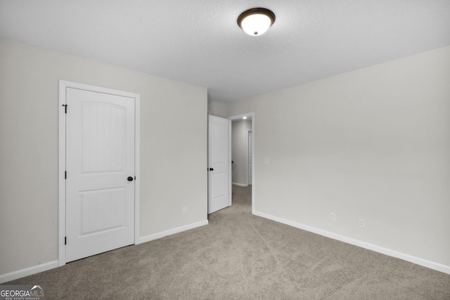 unfurnished bedroom with light carpet and a closet