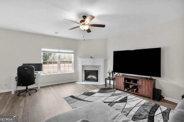 living room with ceiling fan and light hardwood / wood-style floors