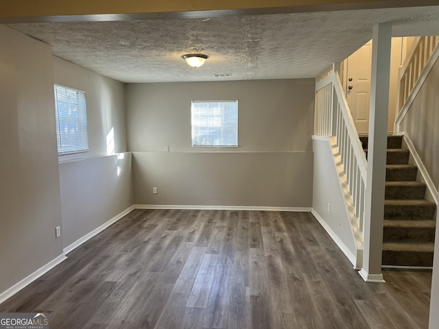 6268 Marbut Farms Trl, Lithonia, GA 30058 - spare room with healthy amount of natural light, stairs, and dark wood-style flooring