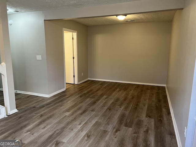 6268 Marbut Farms Trl, Lithonia, GA 30058 - spare room featuring dark wood-style flooring and a textured ceiling