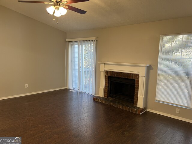 6268 Marbut Farms Trl, Lithonia, GA 30058 - unfurnished living room with ceiling fan, wood finished floors, a fireplace, and healthy amount of natural light