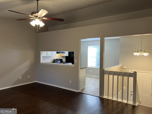 6268 Marbut Farms Trl, Lithonia, GA 30058 - empty room with dark wood-type flooring, a ceiling fan, and a chandelier