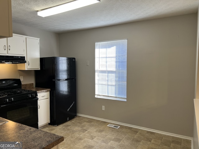 6268 Marbut Farms Trl, Lithonia, GA 30058 - kitchen featuring black appliances, under cabinet range hood, dark countertops, white cabinetry, and a textured ceiling