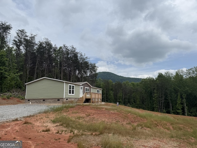 132 Wauka Mountain Rd, Clermont, GA 30527 - manufactured / mobile home featuring crawl space and a forest view