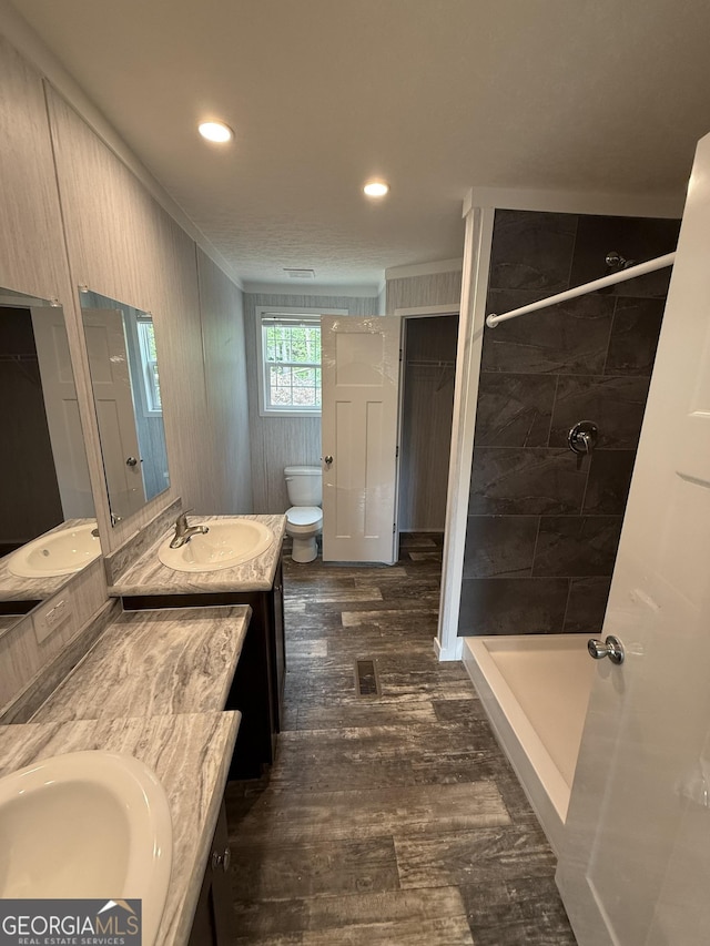 132 Wauka Mountain Rd, Clermont, GA 30527 - full bath featuring ornamental molding, toilet, double vanity, wood finished floors, and a shower stall