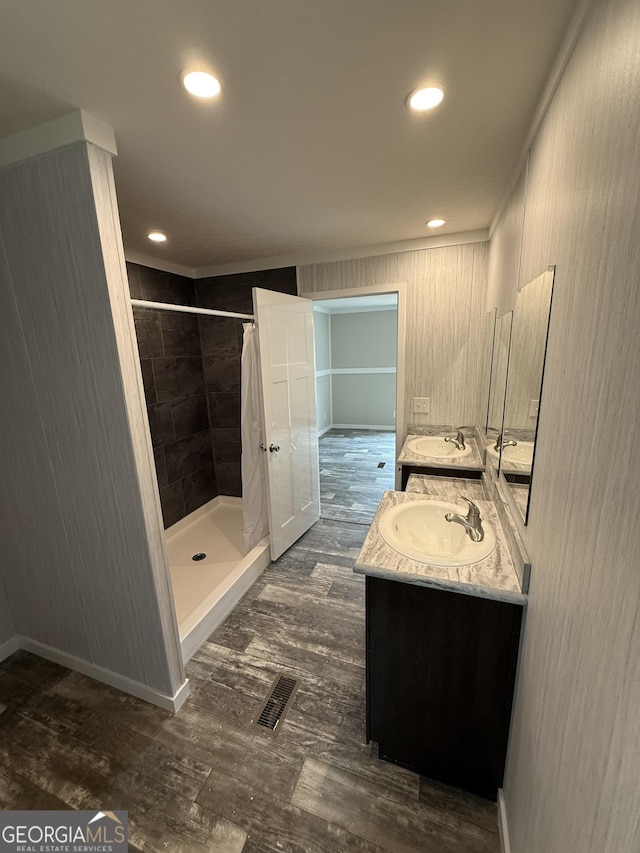 132 Wauka Mountain Rd, Clermont, GA 30527 - full bathroom featuring a stall shower, wood finished floors, double vanity, ornamental molding, and recessed lighting