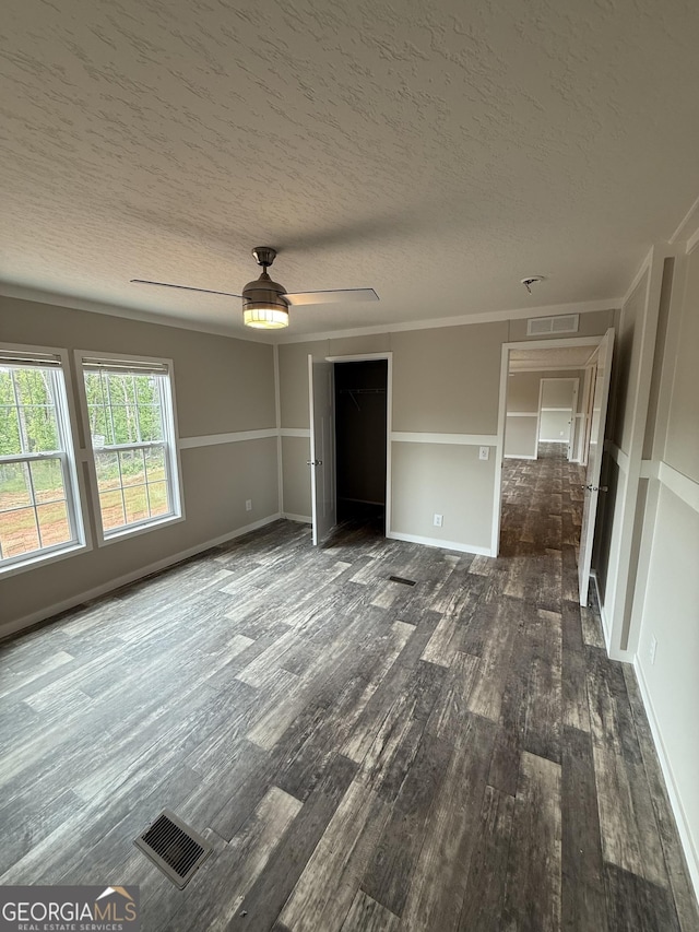 132 Wauka Mountain Rd, Clermont, GA 30527 - spare room with dark wood-style flooring, a textured ceiling, ceiling fan, and crown molding