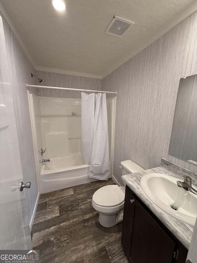 132 Wauka Mountain Rd, Clermont, GA 30527 - full bathroom with wood finished floors, toilet, shower / bath combination with curtain, vanity, and ornamental molding
