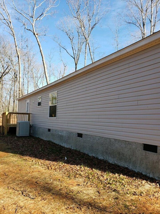 view of side of home with central air condition unit