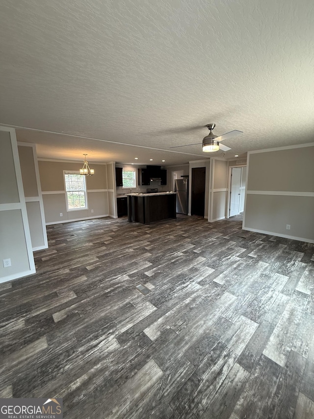132 Wauka Mountain Rd, Clermont, GA 30527 - unfurnished living room featuring dark wood-style floors, a chandelier, a textured ceiling, baseboards, and a ceiling fan