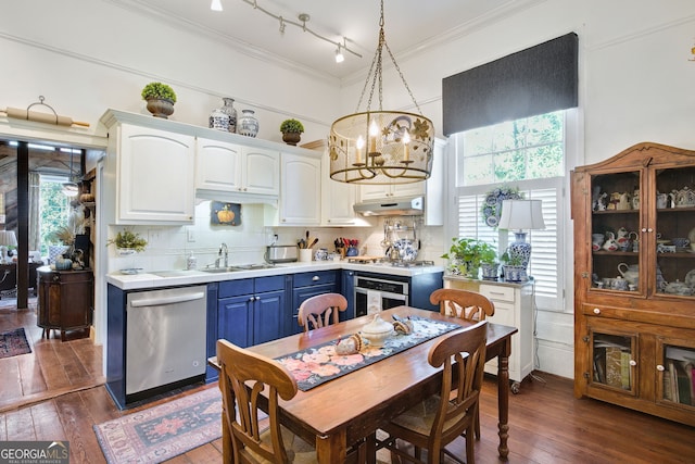 kitchen with sink, hanging light fixtures, appliances with stainless steel finishes, blue cabinetry, and white cabinets