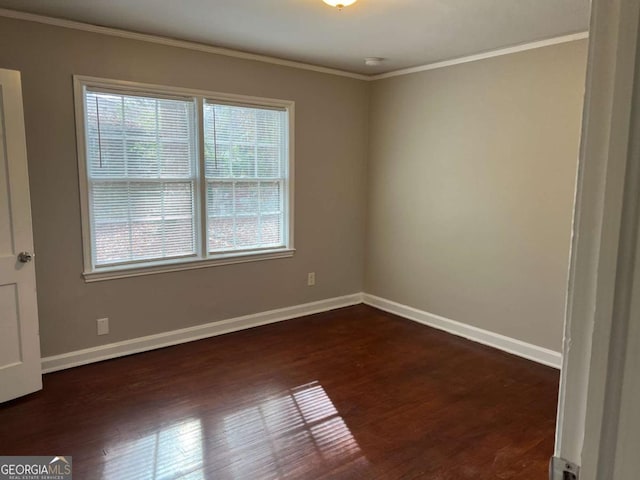 spare room with dark hardwood / wood-style floors and ornamental molding