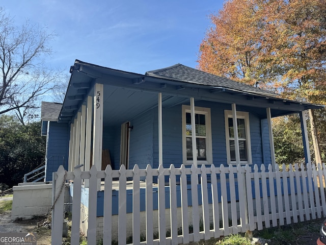 view of side of home with covered porch