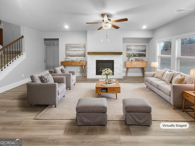 422 Mcdaniel Pl, Canton, GA 30115 - living room featuring a ceiling fan, wood finished floors, stairway, recessed lighting, and a fireplace