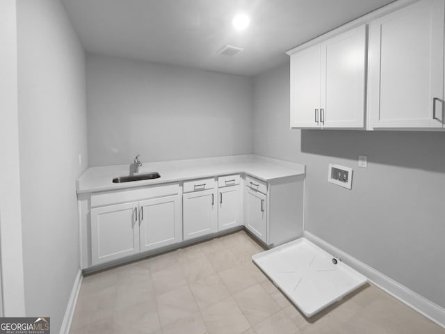 laundry room with cabinets, sink, and hookup for a washing machine