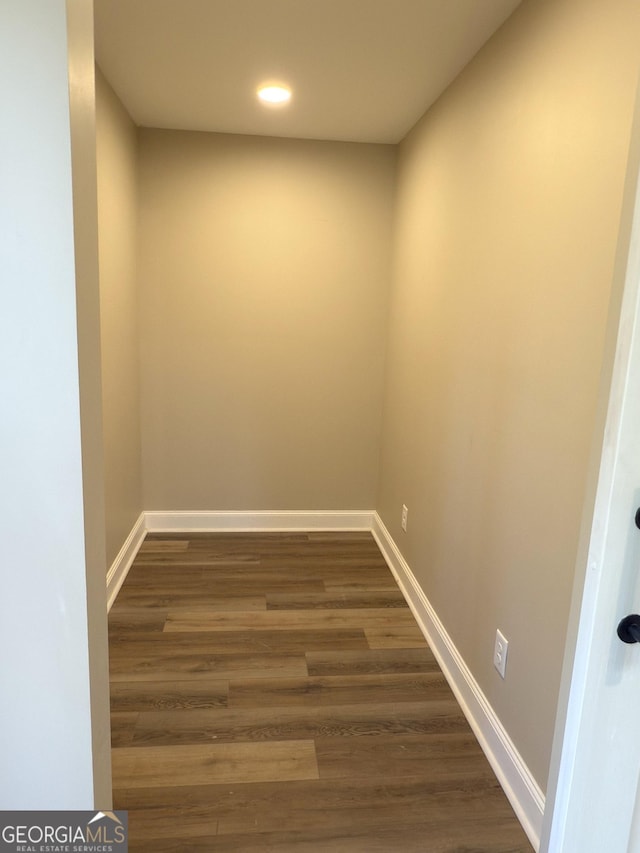 interior space featuring recessed lighting, baseboards, and dark wood finished floors