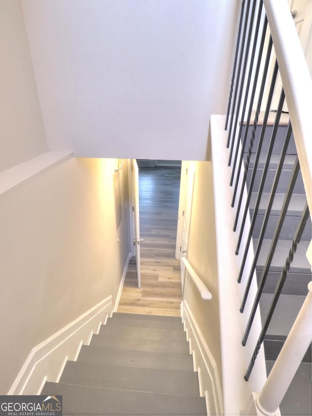 stairway featuring wood-type flooring