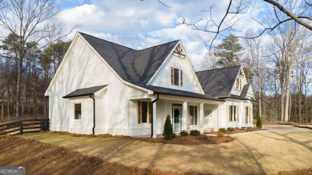 view of side of property with a lawn and a porch