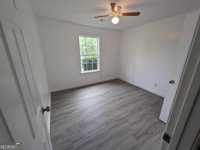 spare room with hardwood / wood-style flooring and ceiling fan