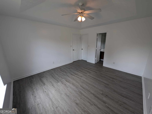 unfurnished room with dark hardwood / wood-style floors and ceiling fan