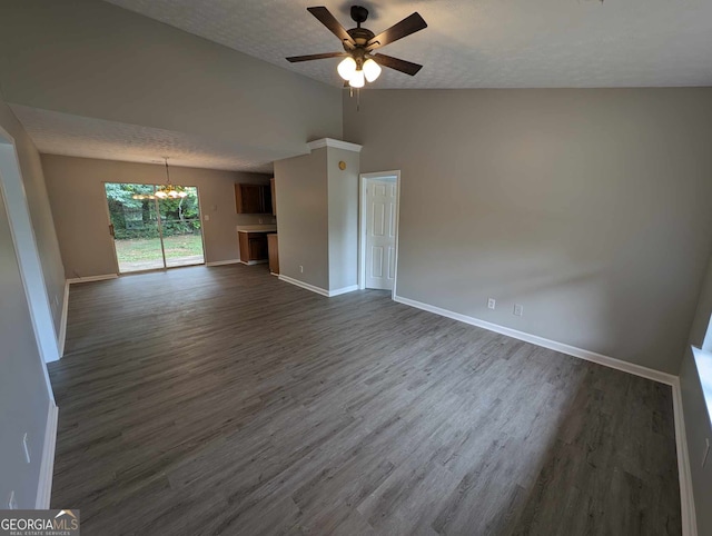 unfurnished living room featuring ceiling fan with notable chandelier, a textured ceiling, dark wood-type flooring, and lofted ceiling