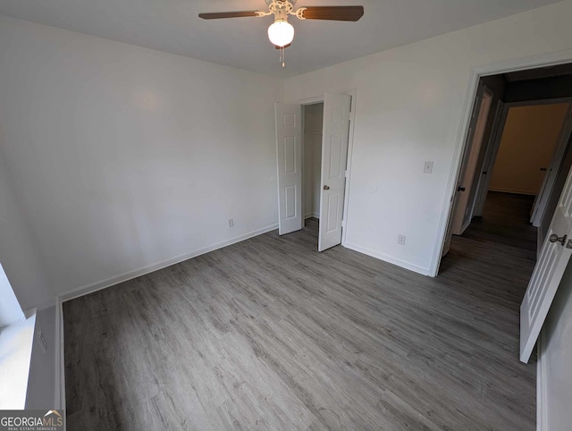 unfurnished bedroom with hardwood / wood-style floors and ceiling fan