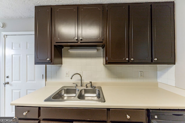 kitchen featuring a textured ceiling, decorative backsplash, sink, and dark brown cabinets