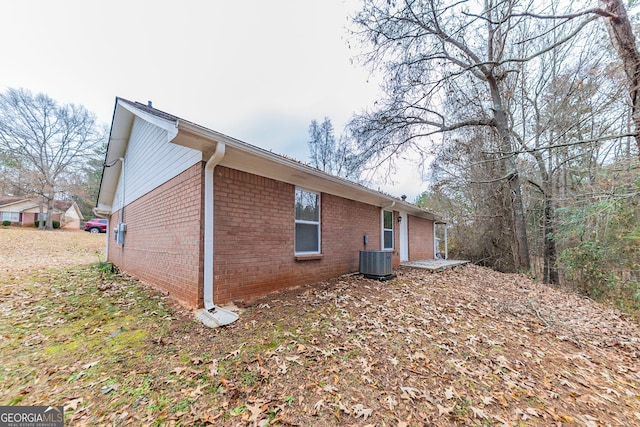 view of side of home featuring cooling unit