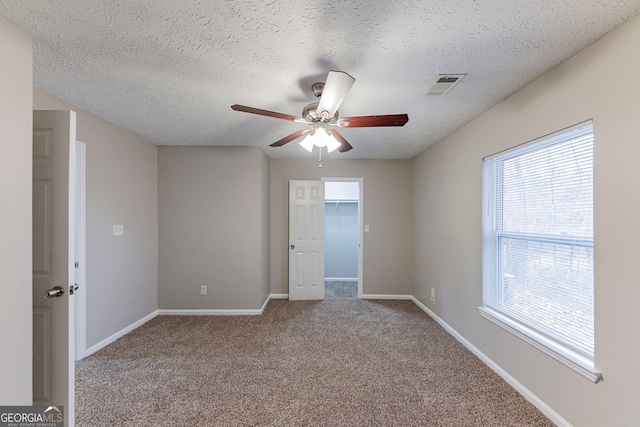 spare room with carpet and a textured ceiling