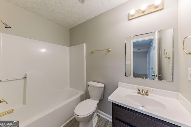 full bathroom with tub / shower combination, vanity, a textured ceiling, wood-type flooring, and toilet