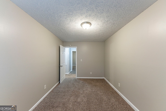 carpeted spare room with a textured ceiling