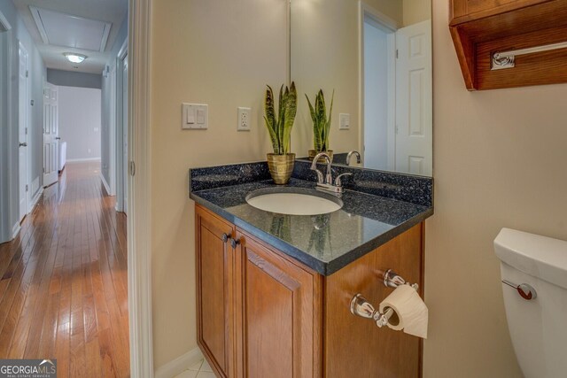 1103 Etowah Valley Ln, Woodstock, GA 30189 - bathroom featuring toilet, vanity, and hardwood / wood-style flooring