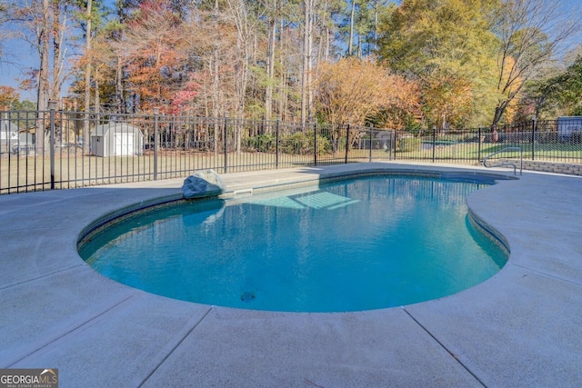 1103 Etowah Valley Ln, Woodstock, GA 30189 - view of swimming pool with a storage shed and a patio