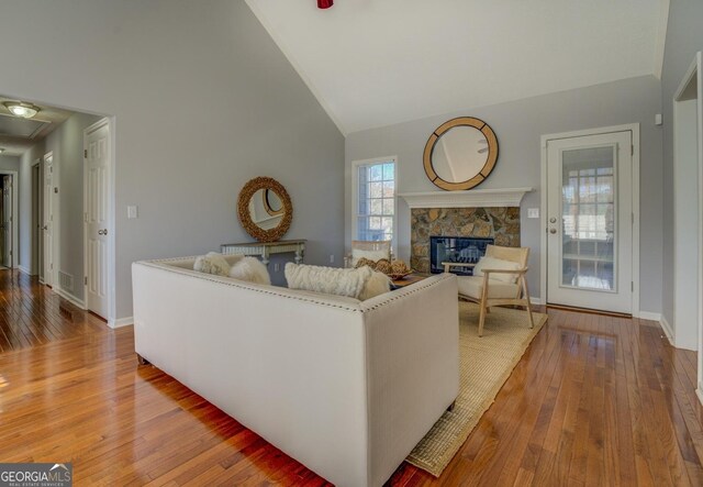 1103 Etowah Valley Ln, Woodstock, GA 30189 - living room featuring a fireplace, hardwood / wood-style flooring, and high vaulted ceiling