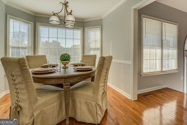 1103 Etowah Valley Ln, Woodstock, GA 30189 - dining area featuring light hardwood / wood-style flooring, a chandelier, and ornamental molding