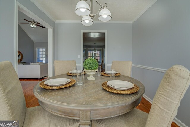 1103 Etowah Valley Ln, Woodstock, GA 30189 - dining area featuring wood-type flooring, ceiling fan with notable chandelier, a wealth of natural light, and crown molding